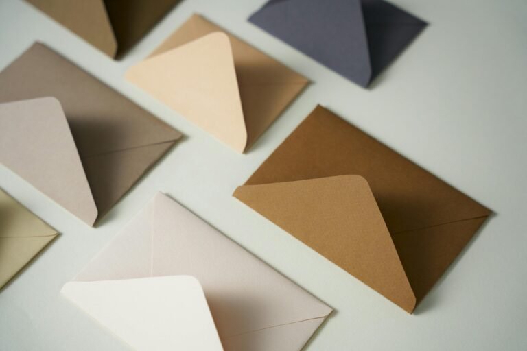 A flat lay arrangement of various colored envelopes in a minimalist style, offering diverse stationery options.